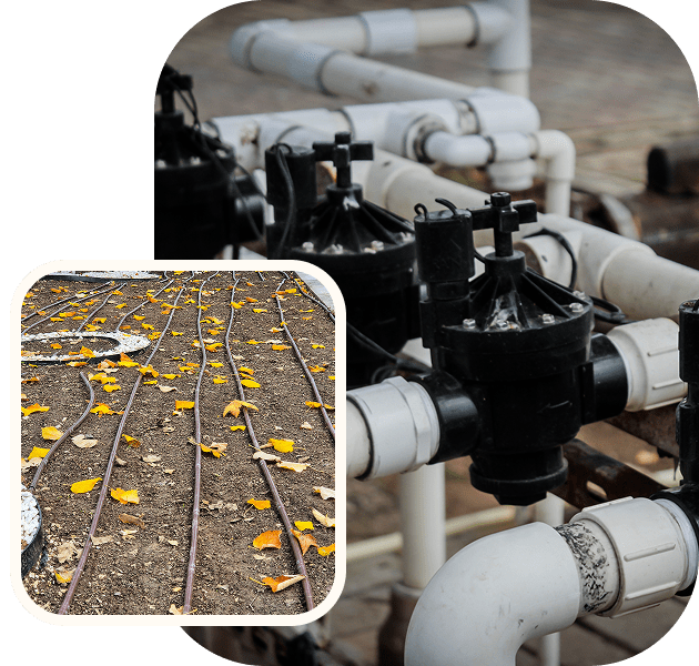 Irrigation pipes and valves in garden setting.